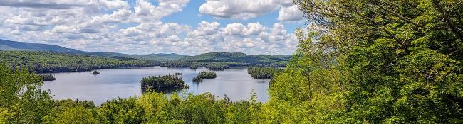 far view of Blue Mountain Lake in the Adirondacks with trees nearby