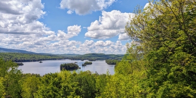 far view of Blue Mountain Lake in the Adirondacks with trees nearby