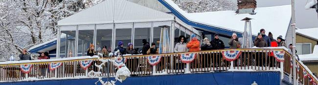 people on deck at lake george beach club in winter