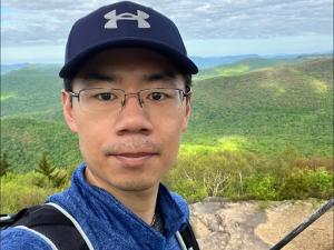 man with glasses with forest background