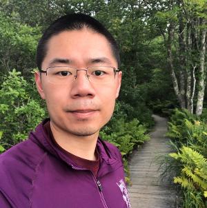 man with glasses with forest background